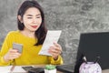 Happy Asian woman paying for electricity bill by smart phone