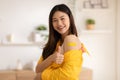 Happy Asian Woman received anti virus vaccine cheerful thumbs up with bandage,young woman enjoying and confident with future