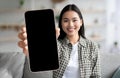 Happy Asian Woman Showing Big Smartphone With Blank Blank Screen At Camera Royalty Free Stock Photo