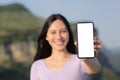 Happy asian woman showing blank smart phone screen Royalty Free Stock Photo