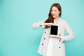 Happy asian woman smile and holding tablet isolated over light green background Royalty Free Stock Photo