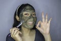 Happy Asian women smiling when she use brush to beauty face mask Royalty Free Stock Photo