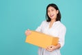 Happy Asian woman smiling in white casual dress standing smiling and looking at camera. She is holding package parcel box isolated Royalty Free Stock Photo