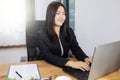 Happy asian woman Smiling and working her laptop on desk. Business woman concept in modern office Royalty Free Stock Photo