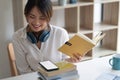 Happy asian woman student busy studying using laptop make notes in notebook, focused man worker employee write watching