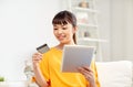 Happy asian woman with tablet pc and credit card Royalty Free Stock Photo