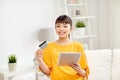 Happy asian woman with tablet pc and credit card Royalty Free Stock Photo