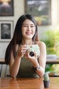 Happy Asian woman taking photo cactus