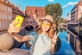 Asian woman taking selfie photo on her smartphone of Peignitz river in Nuremberg city Royalty Free Stock Photo