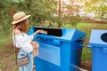 Asian woman throws paper in the trash garbage bin. Waste sorting concept Royalty Free Stock Photo