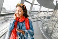 Happy asian woman traveler listen to audioguide in Berlin Reichstag roof at the famous glass dome, Royalty Free Stock Photo