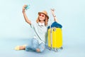 woman traveler with suitcase on color background in studio. Vacation and tourist trip concept Royalty Free Stock Photo