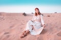 Asian woman in turban travels in Sahara desert. Adventure and life experience concept Royalty Free Stock Photo