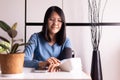 Happy asian woman using blood pressure & heart rate monitors in yourself at home Royalty Free Stock Photo