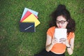 Happy Asian woman using tablet when relaxing in park. People and Royalty Free Stock Photo