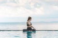 Happy Asian woman wearing black sport wear practice yoga Seated Twist pose on the pool Royalty Free Stock Photo