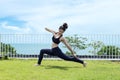 Happy Asian woman wearing black sport wear relaxing in yoga High Lunge twist pose