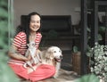 Asian woman sitting in balcony with her golden retriever dog and chihuahua dog , smiling happily at camera.Morning routine,stay Royalty Free Stock Photo