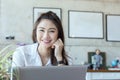 Happy Asian woman wearing white shirt smile and thinking in Coffee shop cafe Royalty Free Stock Photo