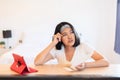 Happy asian woman writing greeting cards at home for next holiday