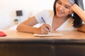 Happy asian woman writing greeting cards at home for next holiday Royalty Free Stock Photo