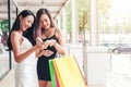 Happy Asian women friendship Enjoying Spending shopping bags in Fashion shopping street