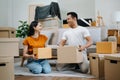 Happy asian young attractive couple man and woman with big boxes moving into a new house, new apartment for couple the new home, Royalty Free Stock Photo