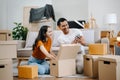 Happy asian young attractive couple man and woman with big boxes moving into a new house, new apartment for couple the new home, Royalty Free Stock Photo