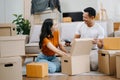 Happy asian young attractive couple man and woman with big boxes moving into a new house, new apartment for couple the new home, Royalty Free Stock Photo