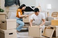 Happy asian young attractive couple man and woman with big boxes moving into a new house, new apartment for couple the new home, Royalty Free Stock Photo