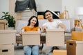 Happy asian young attractive couple man and woman with big boxes moving into a new house, new apartment for couple the new home, Royalty Free Stock Photo