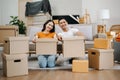 Happy asian young attractive couple man and woman with big boxes moving into a new house, new apartment for couple the new home, Royalty Free Stock Photo