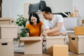 Happy asian young attractive couple man and woman with big boxes moving into a new house, new apartment for couple the new home, Royalty Free Stock Photo