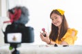 Happy Asian young beauty blogger girl training how to be make up artist in home studio. Woman speaking in front of camera as Royalty Free Stock Photo