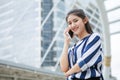 Happy asian young business woman talking on mobile phone in urban city . outdoor Royalty Free Stock Photo