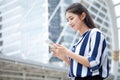 Happy asian young businesswoman talking on mobile phone in urban city . outdoor Royalty Free Stock Photo