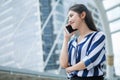 Happy asian young business woman talking on mobile phone in city . outdoor Royalty Free Stock Photo