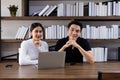 Happy Asian young Businesswoman and Business man working laptop computer on wood desk in Home office Royalty Free Stock Photo