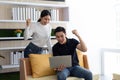 Happy Asian young Businesswoman and Business man working laptop computer on wood desk in Home office Royalty Free Stock Photo