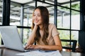 businesswoman sitting alone at cafe desk with laptop computer she looking out of window Royalty Free Stock Photo