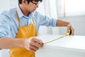 Happy asian young carpenter home improvement Assembling measuring the furniture Moving into New House Renovation concept