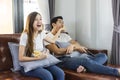 Happy asian young couple on the couch watching a movie together. Royalty Free Stock Photo