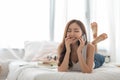 Asian Young Female lying on bed talking on phone Royalty Free Stock Photo