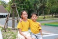 Happy Asian young girl child and little boy kid hug the neck and smile. Portrait Caucasian little brother and older sister hugging Royalty Free Stock Photo