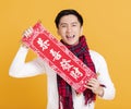 Happy asian young man celebrating  chinese new year. chinese text : congratulation and  get rich Royalty Free Stock Photo