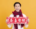 Happy asian young man celebrating  chinese new year. chinese text : congratulation and  get rich Royalty Free Stock Photo