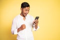 happy asian young man looking at a mobile phone Royalty Free Stock Photo