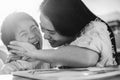 Happy asian young mother having fun with her child outdoors in summer sunny day - Focus on woman face Royalty Free Stock Photo