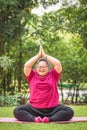 Young woman with down syndrome or autism doing yoga outdoors