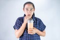 Happy Asian young woman is drinking Thai tea with milk. Popular beverage in Asia Royalty Free Stock Photo